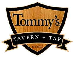 Logo of Tommy's Tavern + Tap, featuring the establishment's name on a wooden shield design with a ribbon at the bottom stating "Est. 2015".